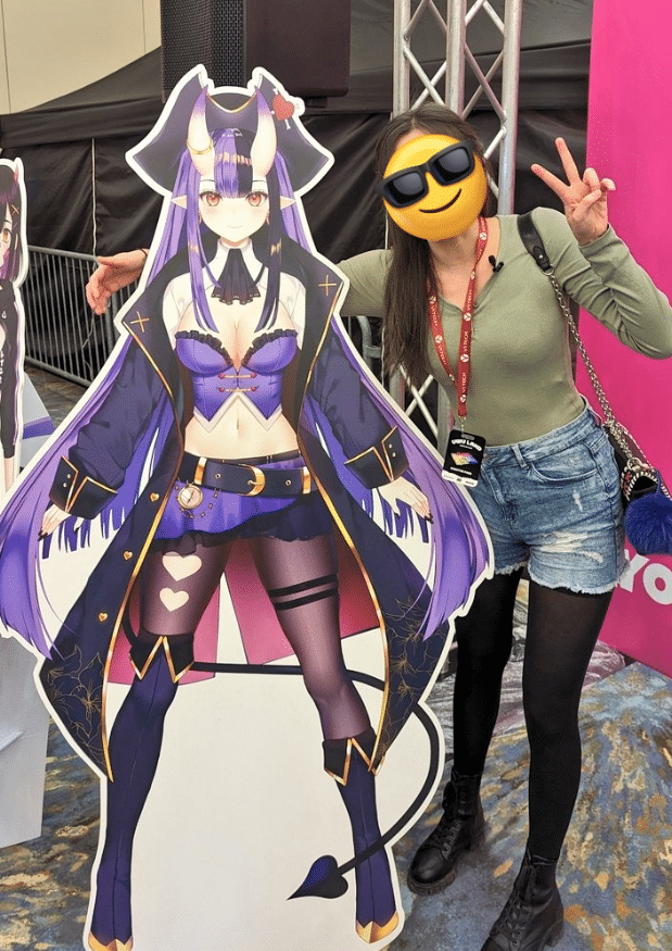 OniGiri standing in real life with her cardboard cutout.