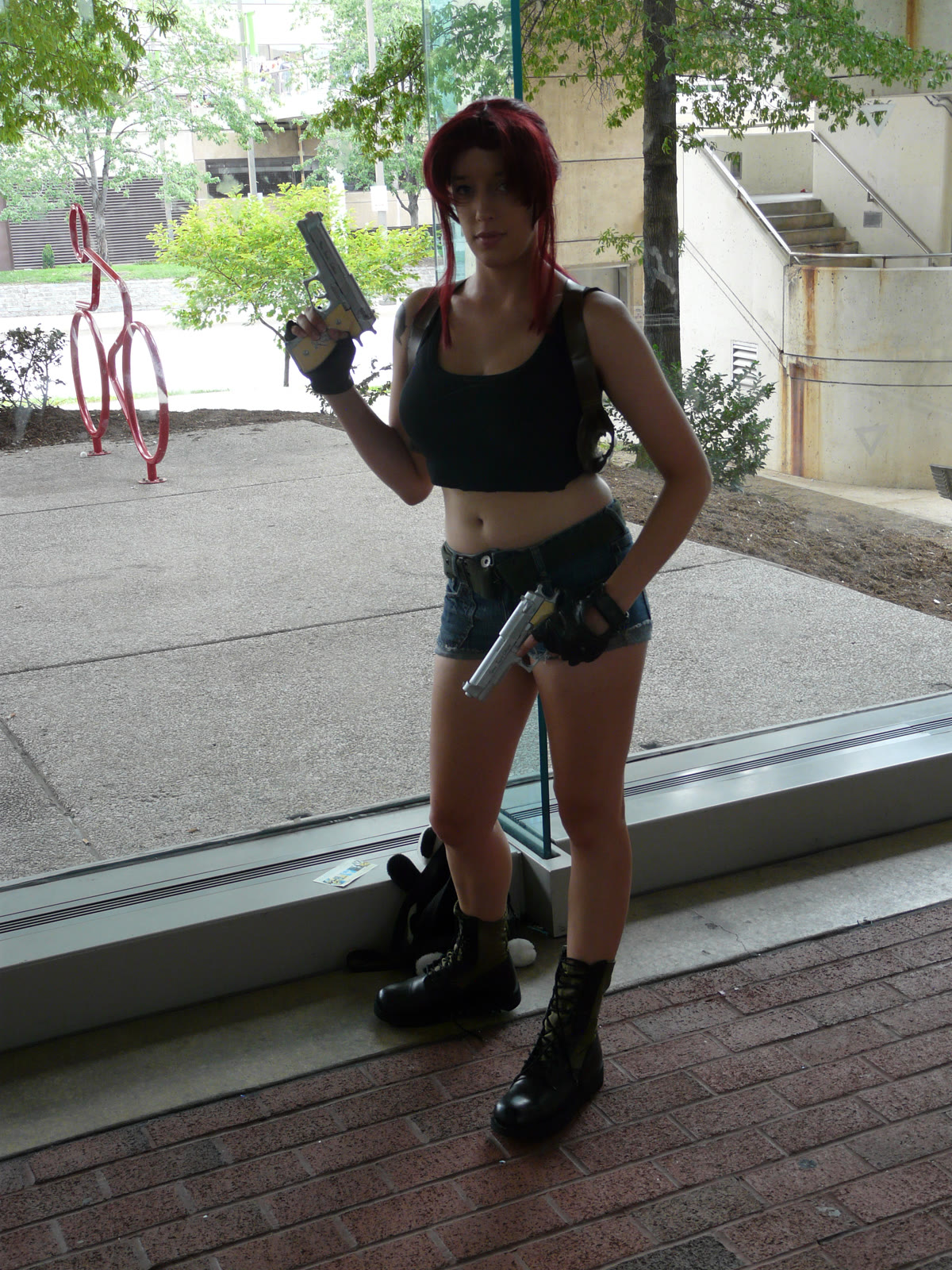 Revy Two Hands from Black Lagoon cosplay dual wielding pistols as the ultimate tomboy in anime