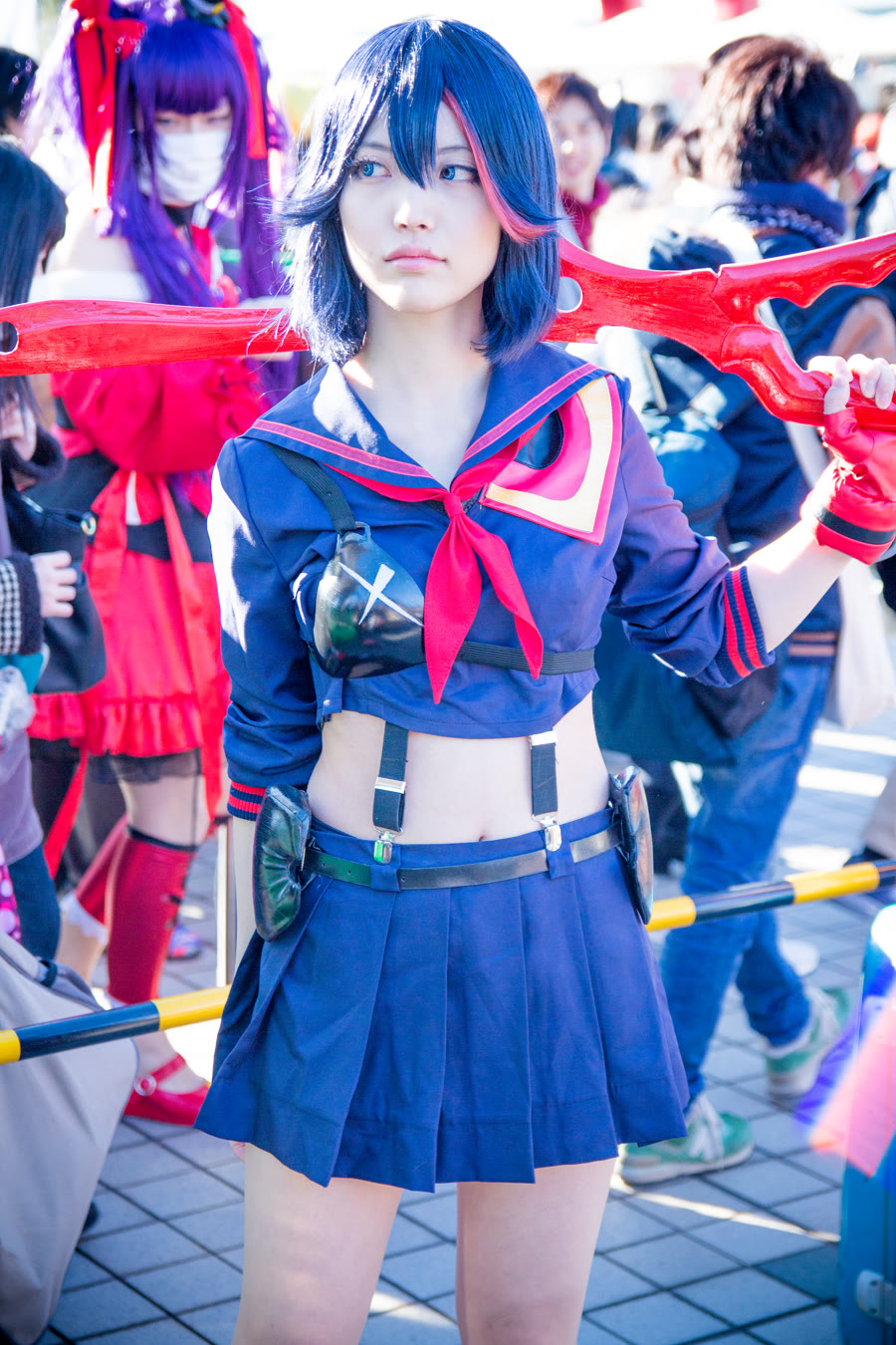 Ryuko Matoi from Kill la Kill cosplay in the red Senketsu sailor uniform, a fierce anime tomboy