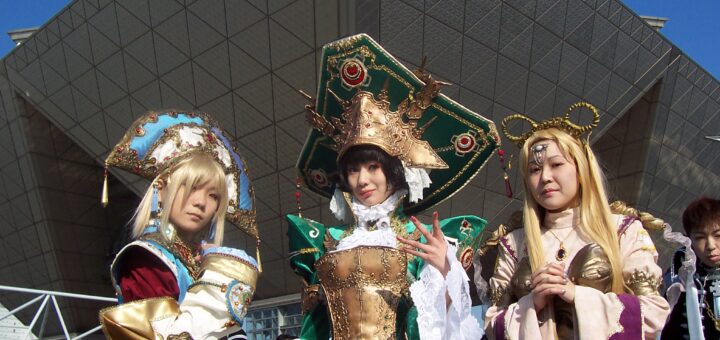 A crowd of anime cosplayers in detailed costumes on a convention floor showing what cosplay is.