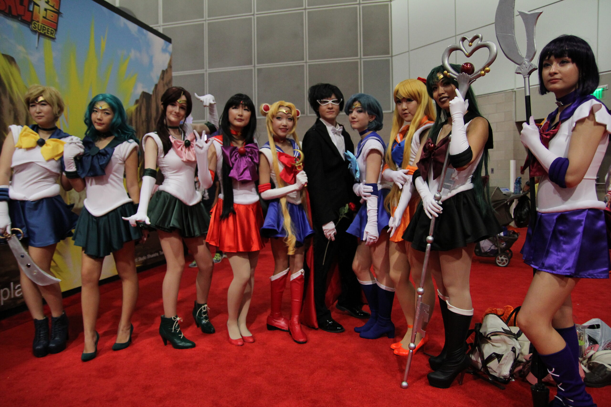 Anime cosplayers posing as the Sailor Moon characters at a convention, showing how anime cosplay took over conventions.
