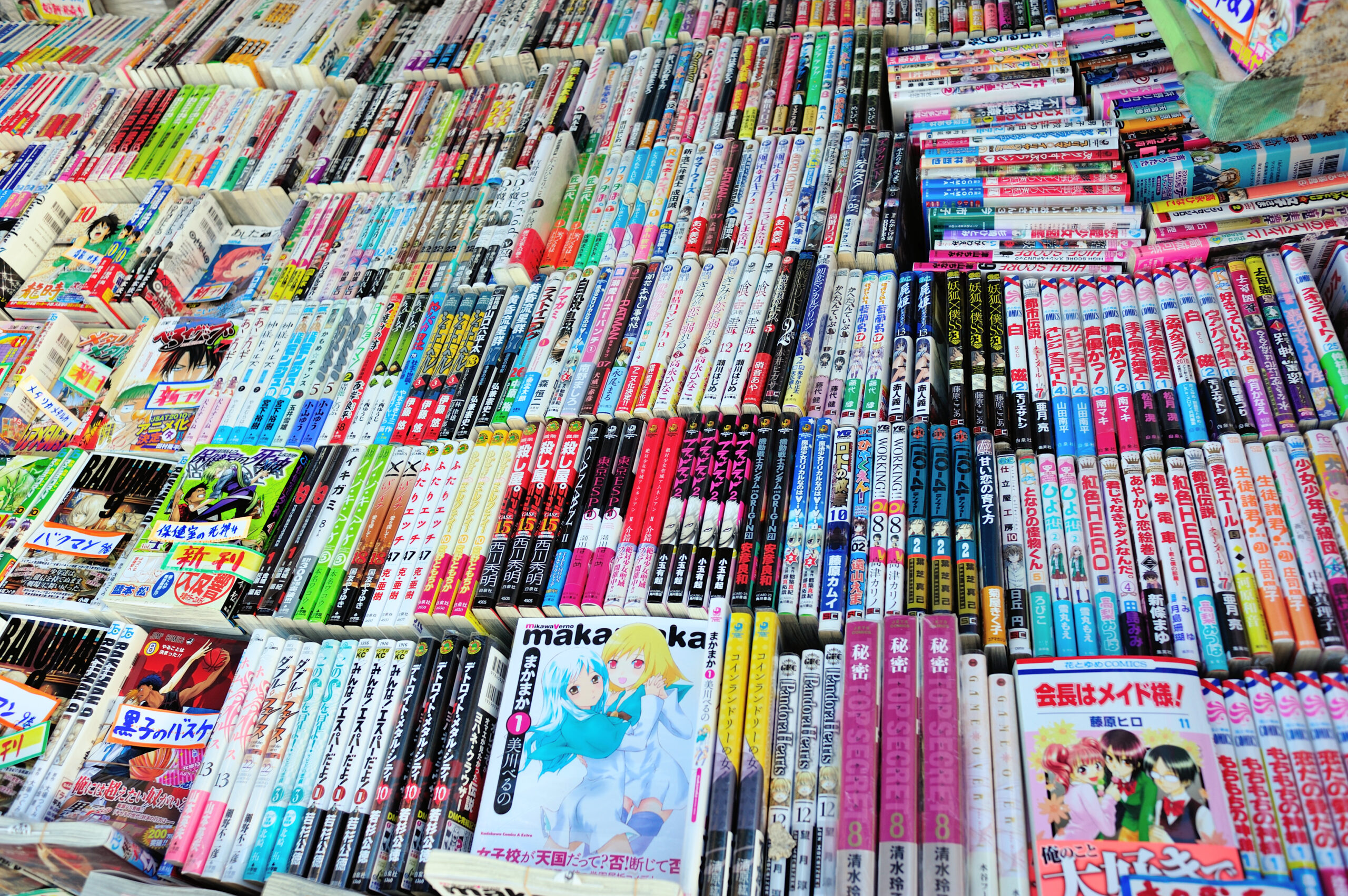 Rows of Japanese manga tankobon volumes for sale across many series and demographics